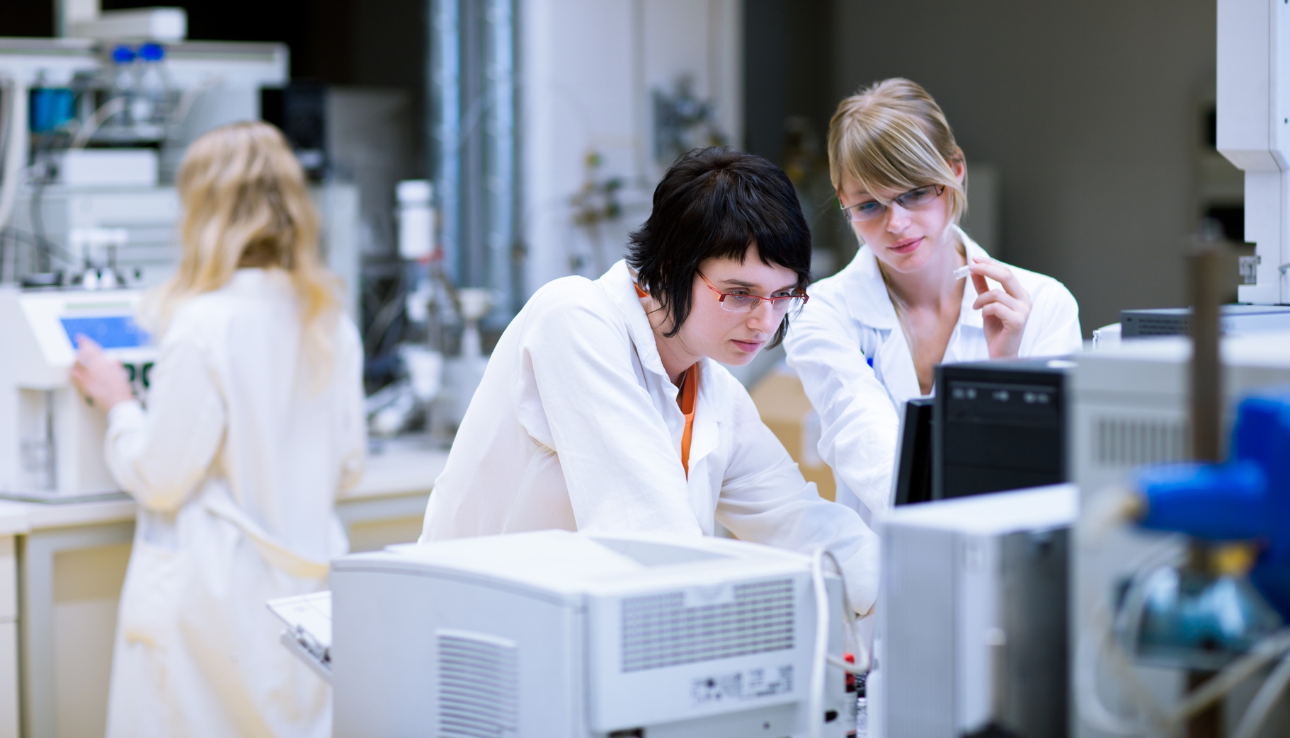 two female researchers/chemistry students doing research in a chemistry lab (color toned image; shallow DOF)